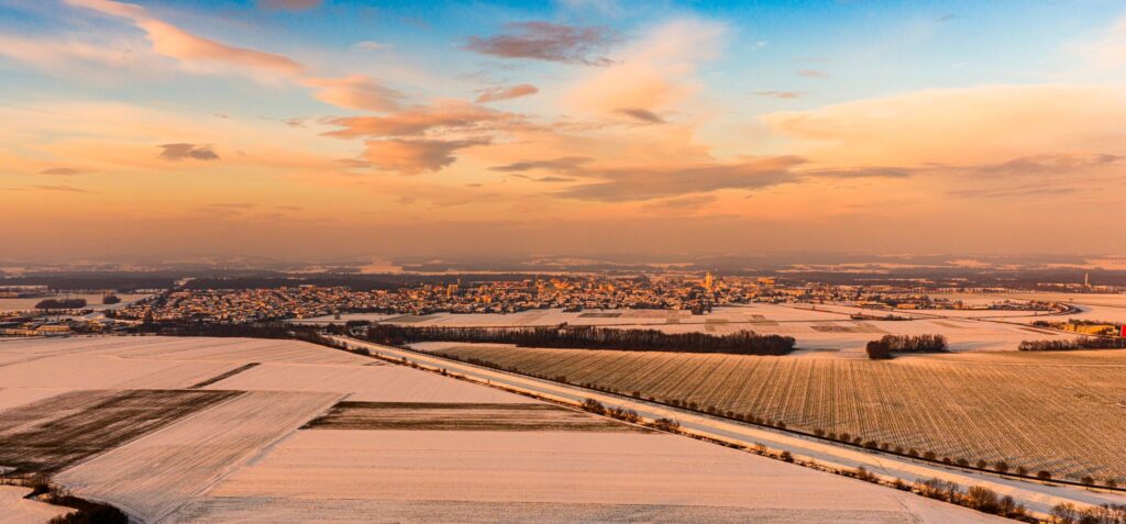 Aerial View of Snow Covered Fields During Winter Sunrise